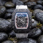 Carbon fiber skeleton watch with bold motorsport design, inspired by luxury chronographs, on wet stones