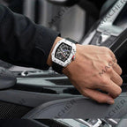Luxury motorsport-inspired watch with carbon fiber case and skeleton dial, worn in high-performance car interior
