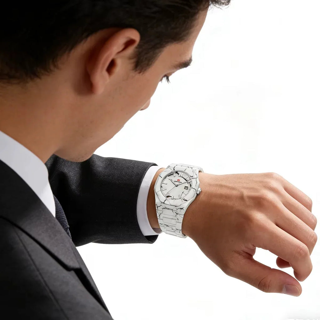 Man in suit wearing a white marble-patterned luxury sports watch on his wrist