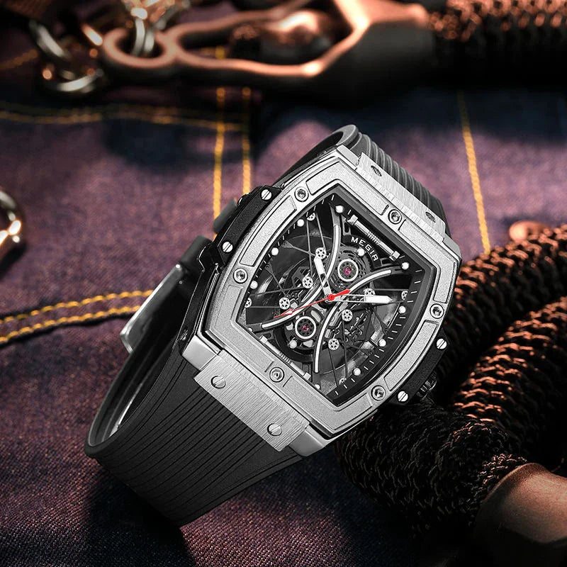 Luxury racing-inspired tonneau watch with skeleton dial and rubber strap on denim backdrop