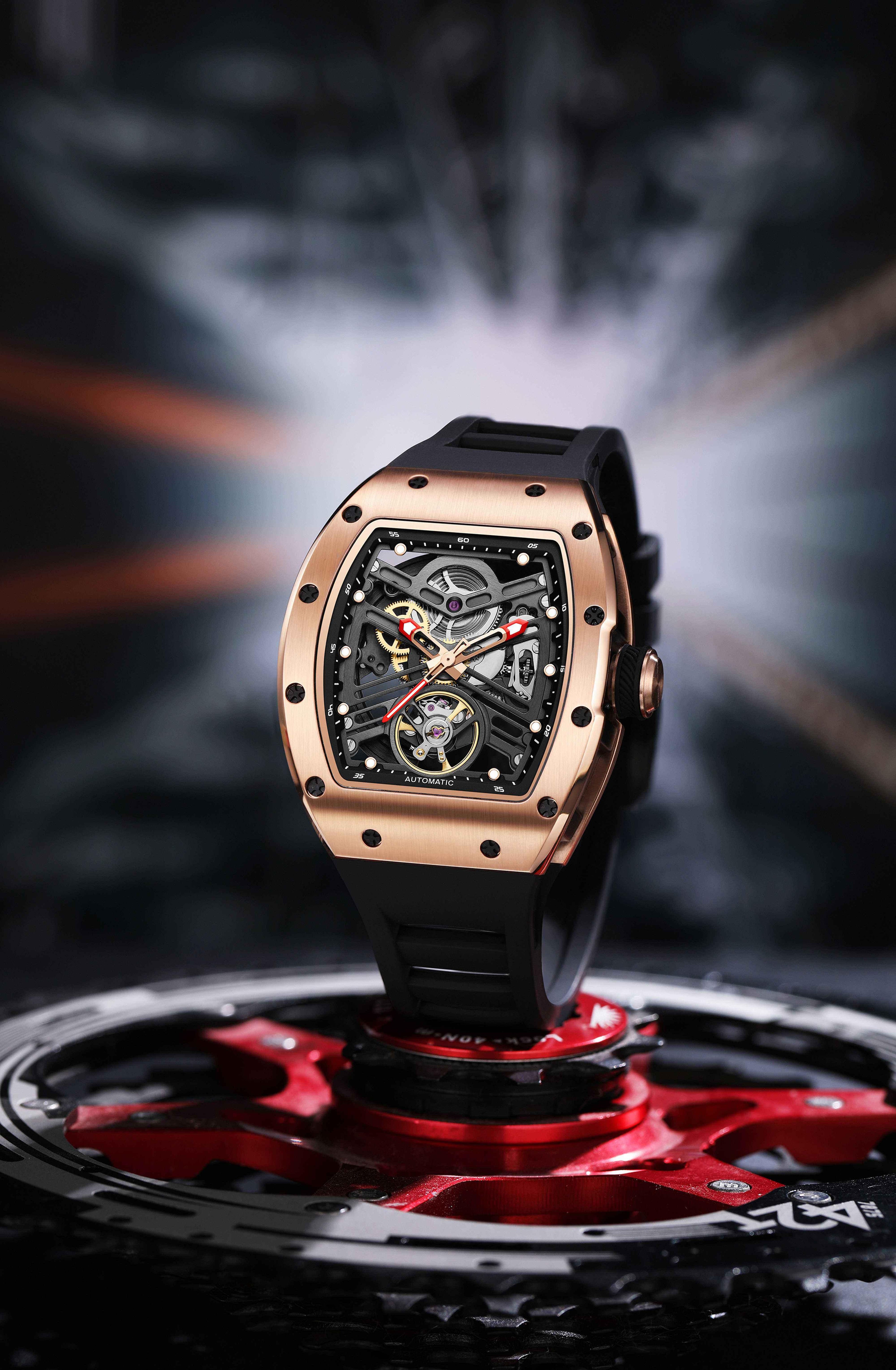 Motorsport-inspired luxury watch with tonneau case, skeleton dial, and black rubber strap