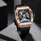 Luxury motorsport-inspired rose gold watch with skeleton dial, black strap, and intricate detailing